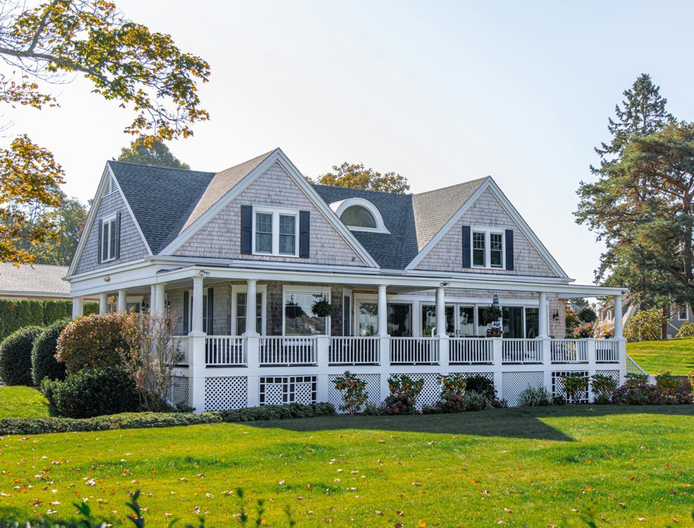 A well-kept home with a wraparound porch