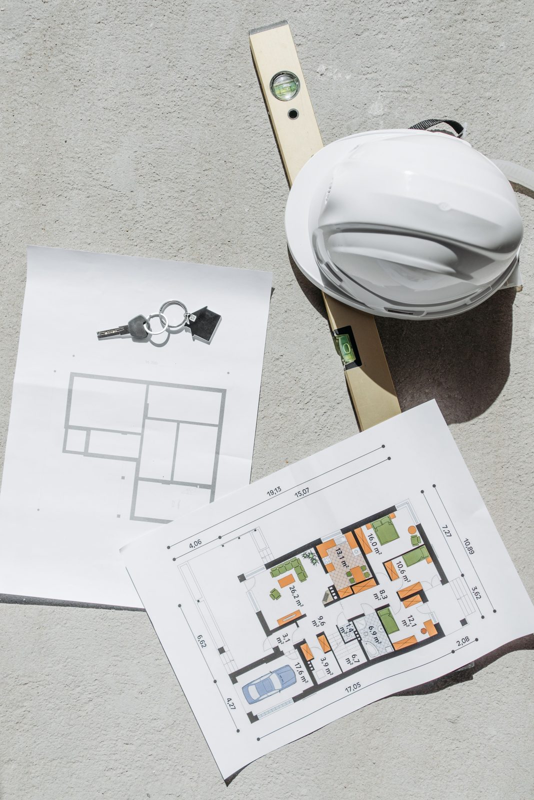 House keys, floor plans, and tools for a home renovation